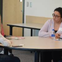 Caylie Peet talking to two students at the 30 Minute Mentors Event
